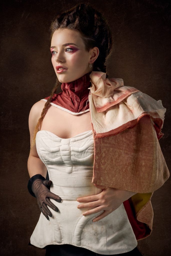 lovely lady in corset, steampunk gloves and cape