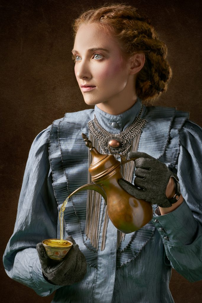 steampunk lady in blue dress with gloves and jewelry